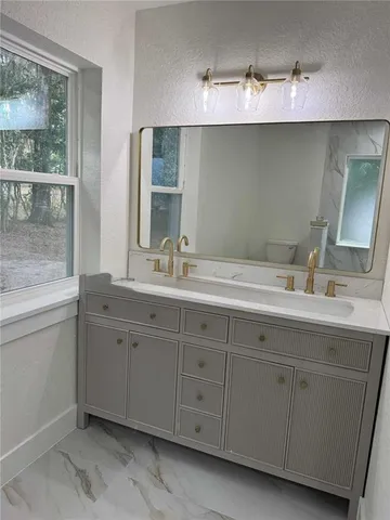 a bathroom with a double vanity sink and mirror