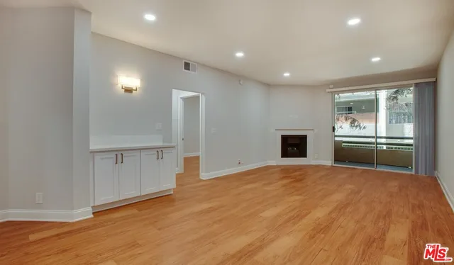 a view of a kitchen with a sink and a refrigerator