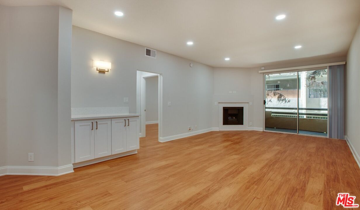 1420 Peerless Place, Unit 213 Los Angeles, CA 90035 - Photo 2 of 10 a view of a kitchen with a sink and a refrigerator