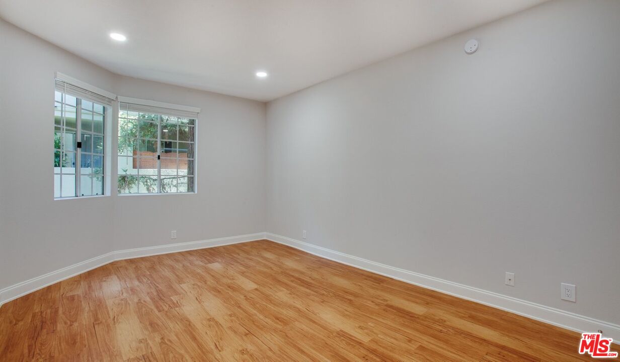 1420 Peerless Place, Unit 213 Los Angeles, CA 90035 - Photo 3 of 10 wooden floor in an empty room with a window