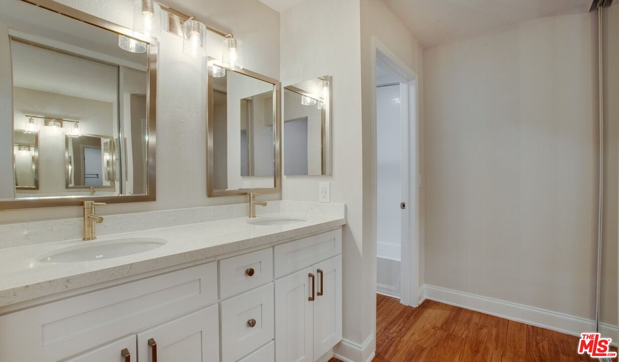 1420 Peerless Place, Unit 213 Los Angeles, CA 90035 - Photo 4 of 10 a bathroom with a sink and a mirror