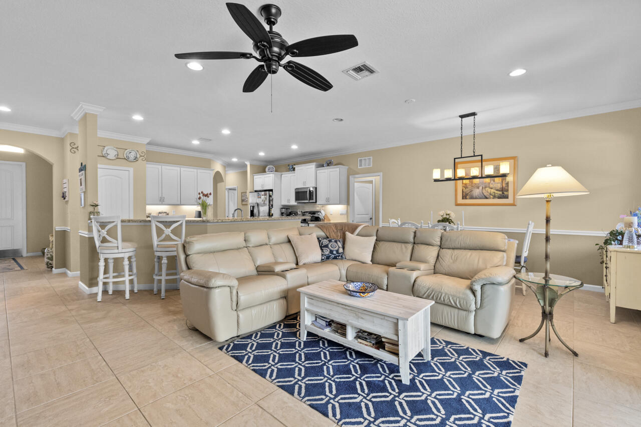 2190 Northwest Dalea Way Stuart, FL 34994 - Photo 16 of 31 a living room with lots of furniture and a chandelier