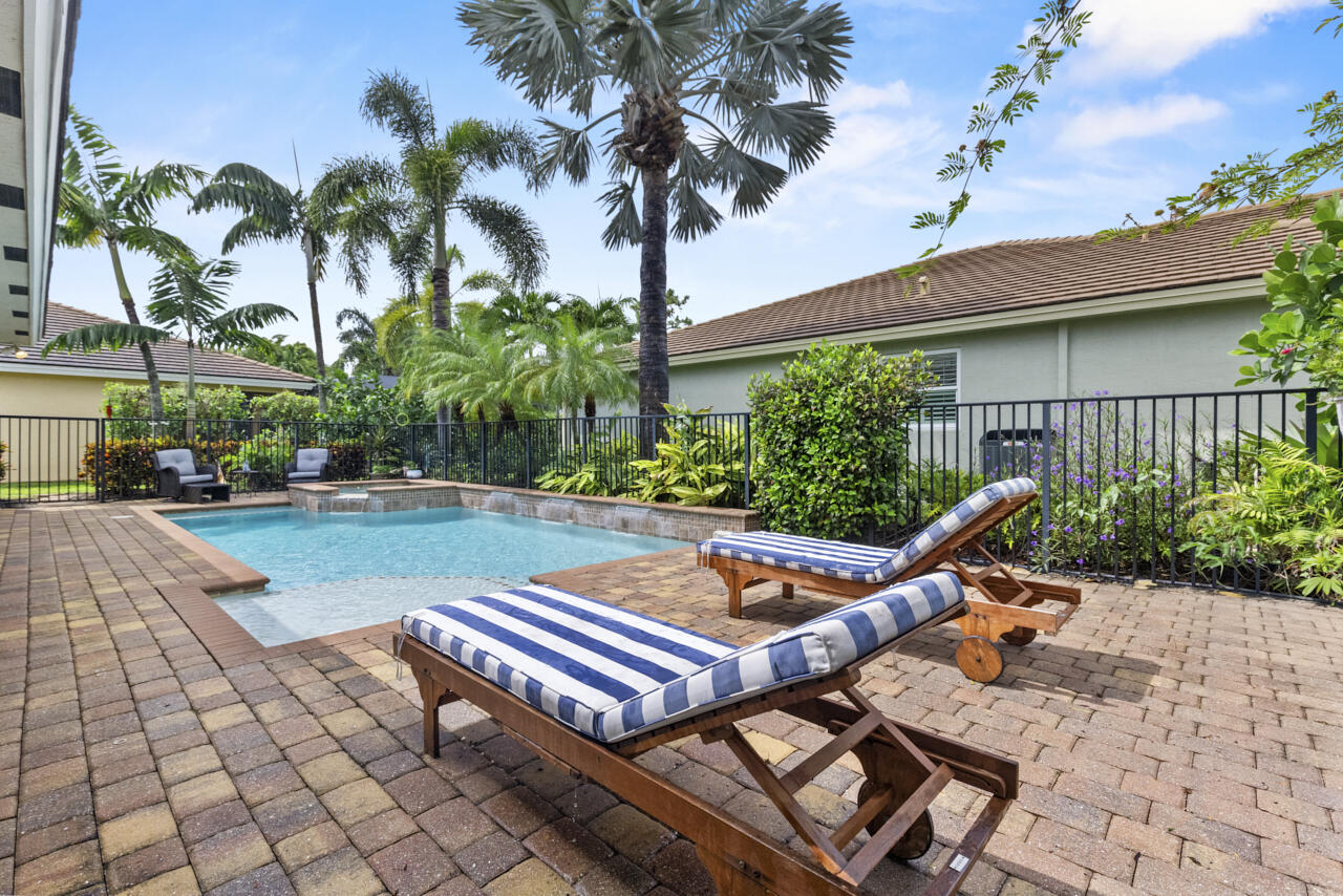 2190 Northwest Dalea Way Stuart, FL 34994 - Photo 2 of 31 a front view of a house with garden and trees