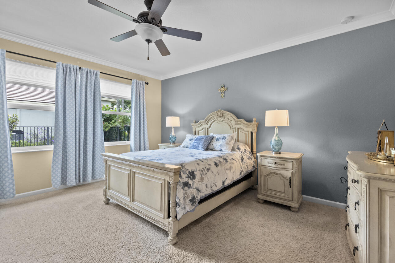 2190 Northwest Dalea Way Stuart, FL 34994 - Photo 5 of 31 a bed sitting in a room next to a window