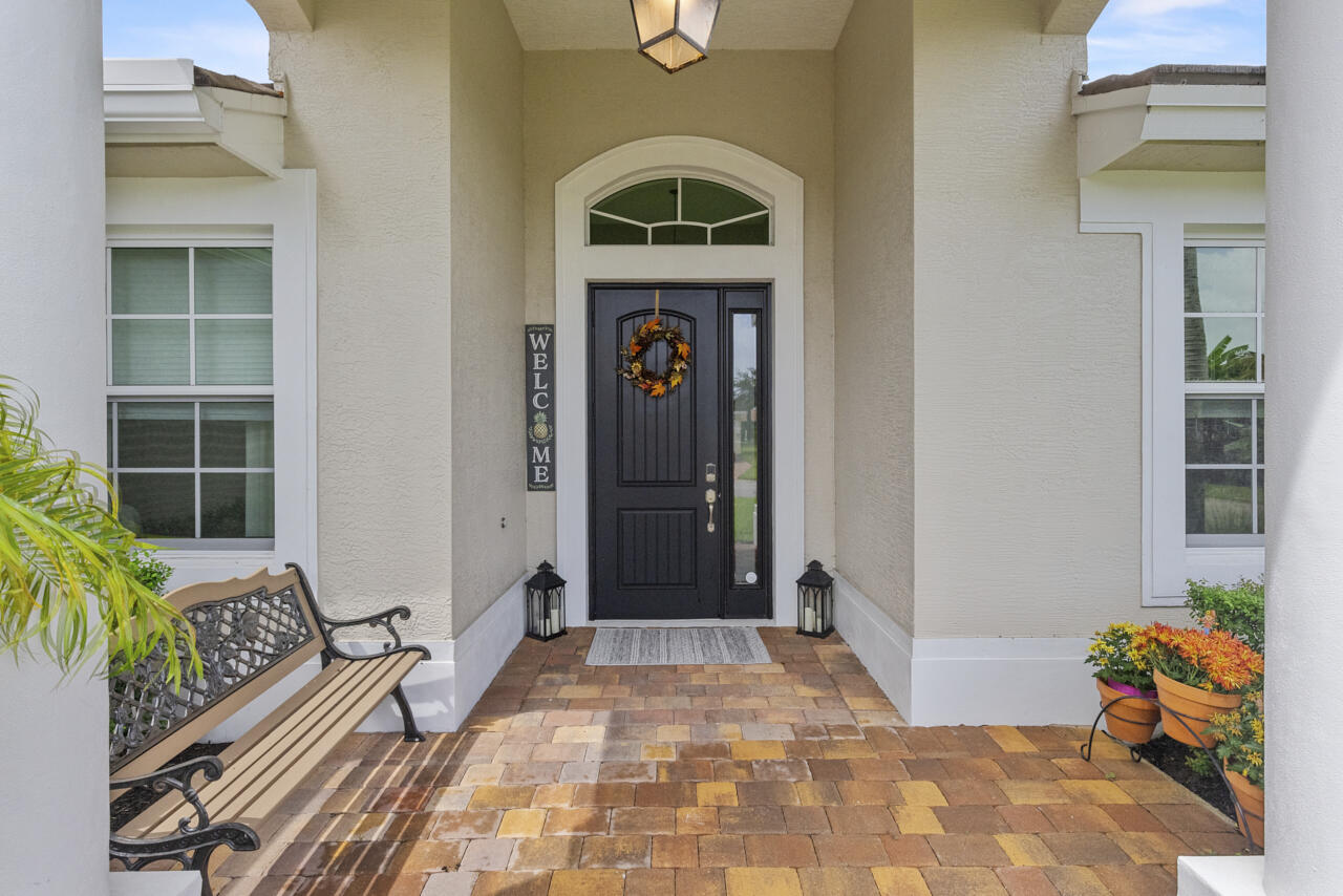 2190 Northwest Dalea Way Stuart, FL 34994 - Photo 10 of 31 a front view of a house with outdoor seating