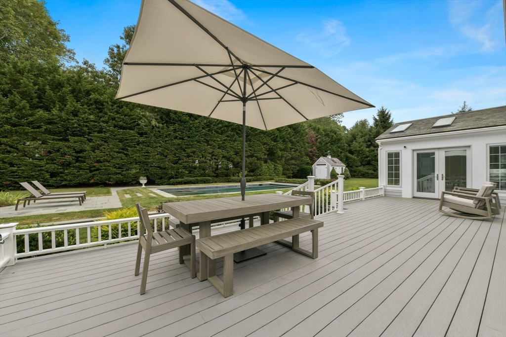 1460 South County Road Barnstable, MA 02655 - Photo 38 of 40 deck with table and chairs under an umbrella