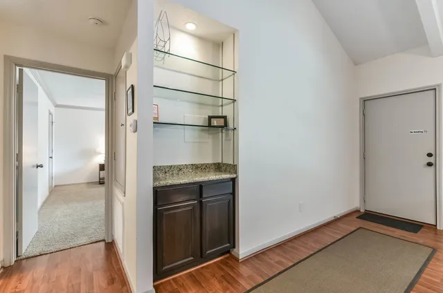a view of empty room with wooden floor