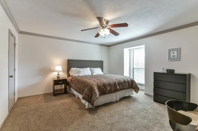 a bedroom with a bed and window