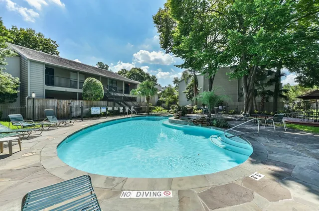 a view of a swimming pool with a patio