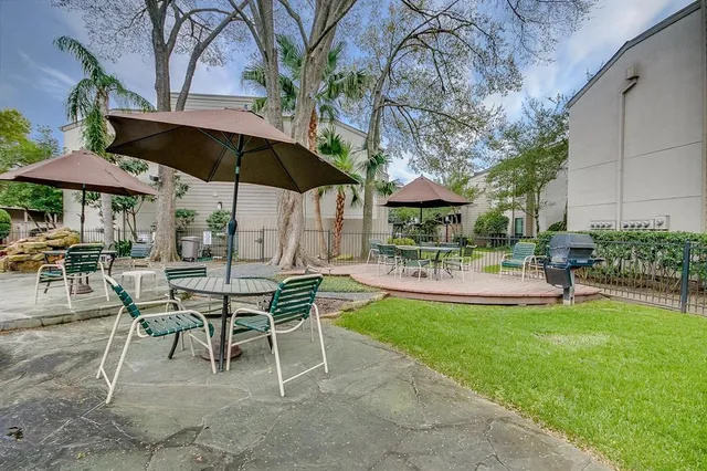 a view of a backyard with sitting area