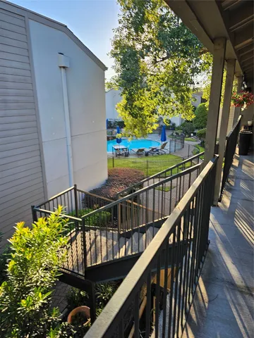 a view of a balcony with wooden floor