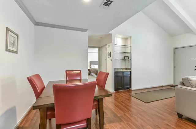 a workspace with furniture wooden floor and a window