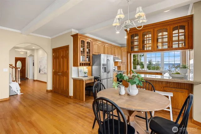 a view of a dining room with furniture a chandelier and wooden floor