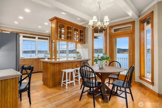 a dining room with furniture a chandelier and wooden floor