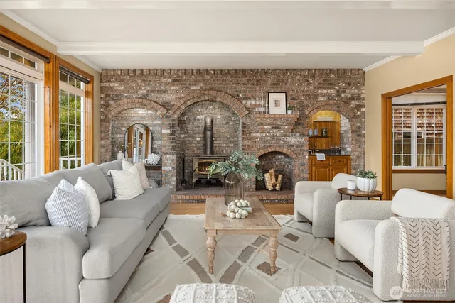 a living room with furniture fireplace and outdoor view