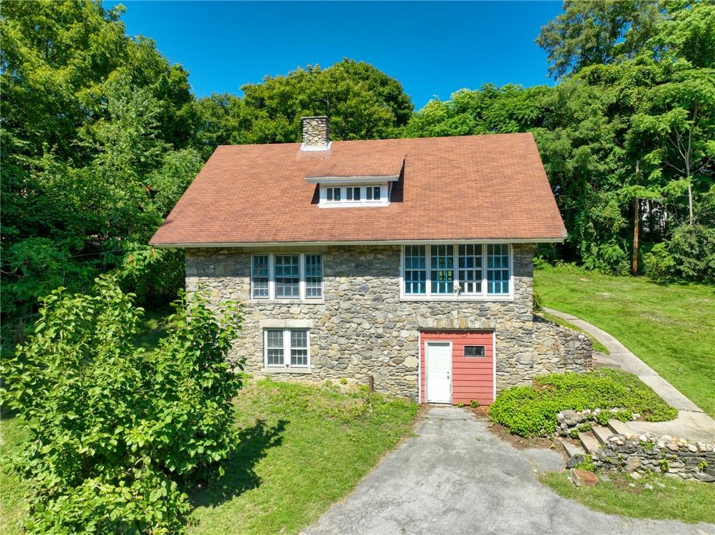 a front view of a house with garden