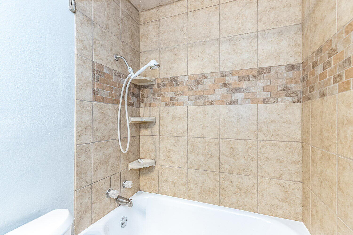 2603 39th Street Lubbock, TX 79413 - Photo 14 of 19 a bathroom with a bathtub and toilet