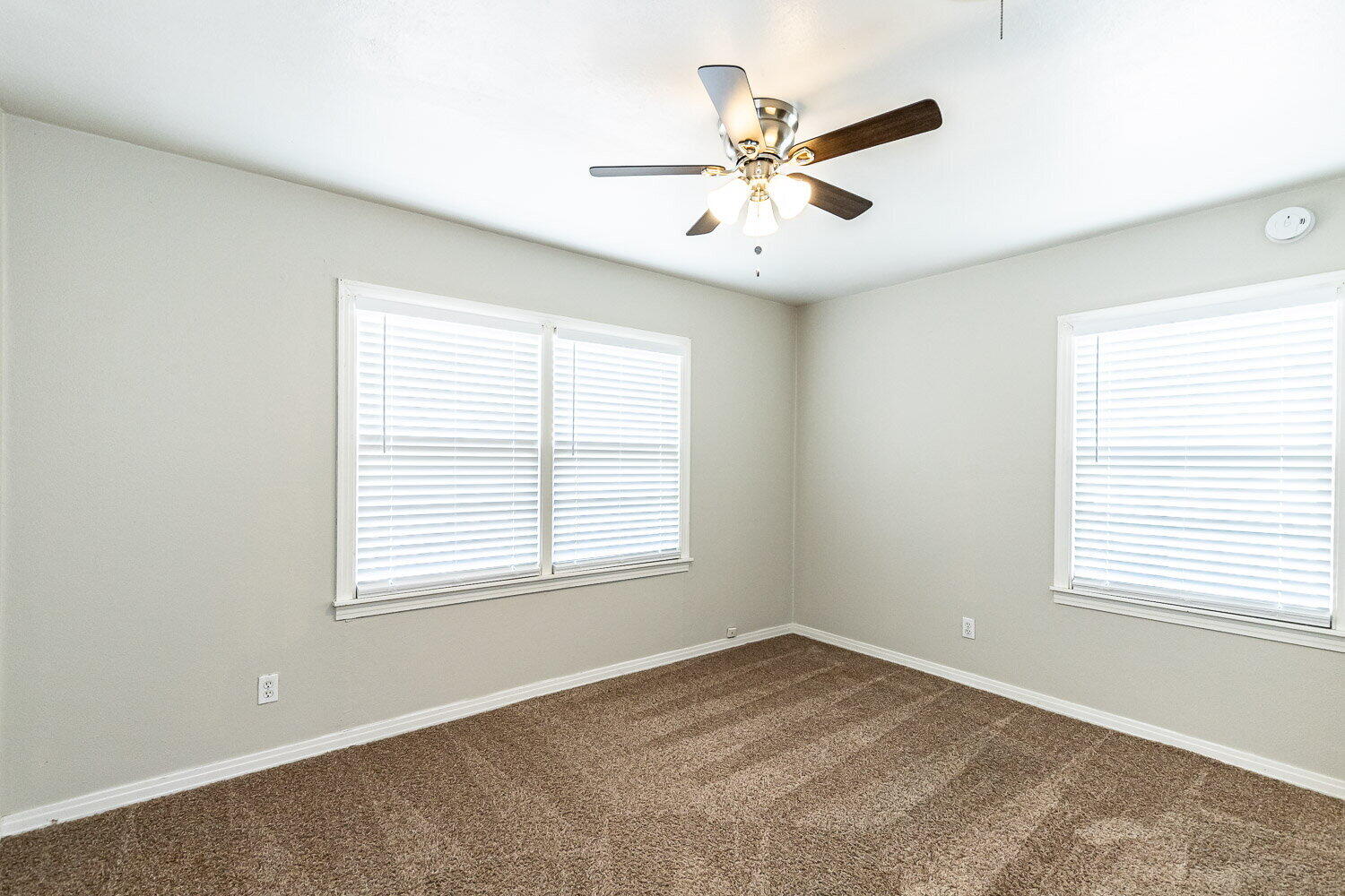2603 39th Street Lubbock, TX 79413 - Photo 17 of 19 an empty room with a window and a fan