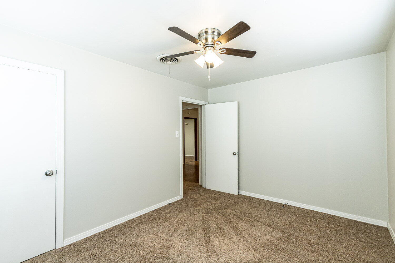 2603 39th Street Lubbock, TX 79413 - Photo 18 of 19 an empty room with a ceiling fan and a window