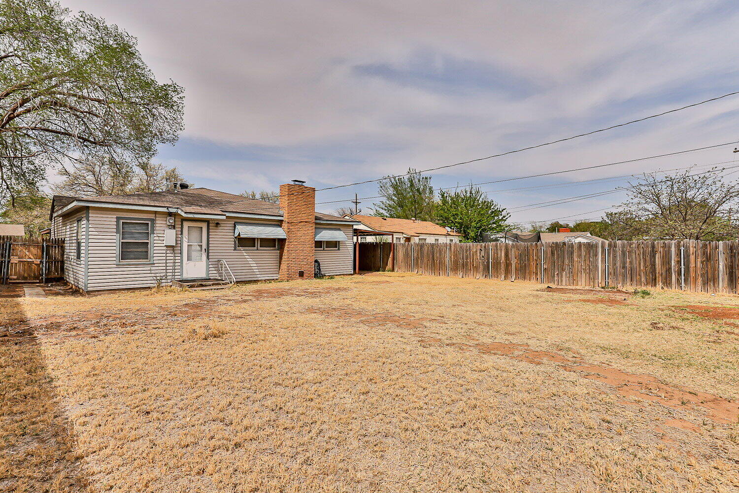 2603 39th Street Lubbock, TX 79413 - Photo 19 of 19 a front view of a house with a yard and garage