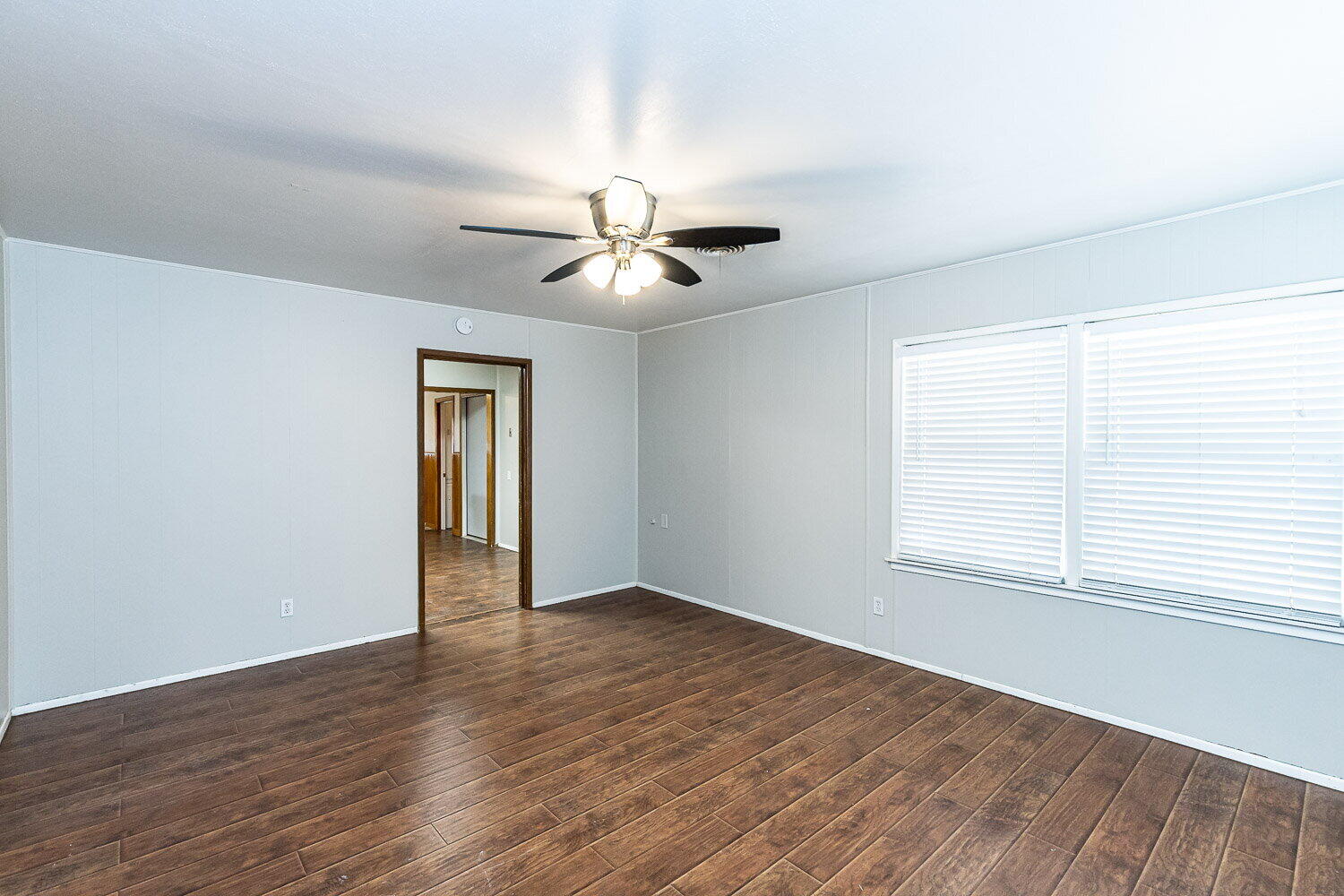 2603 39th Street Lubbock, TX 79413 - Photo 2 of 19 wooden floor in an empty room with a window