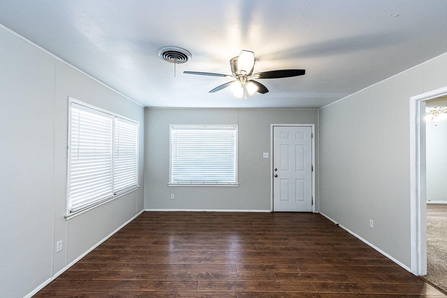 2603 39th Street Lubbock, TX 79413 - Photo 3 of 19 a view of an empty room with a window and wooden floor