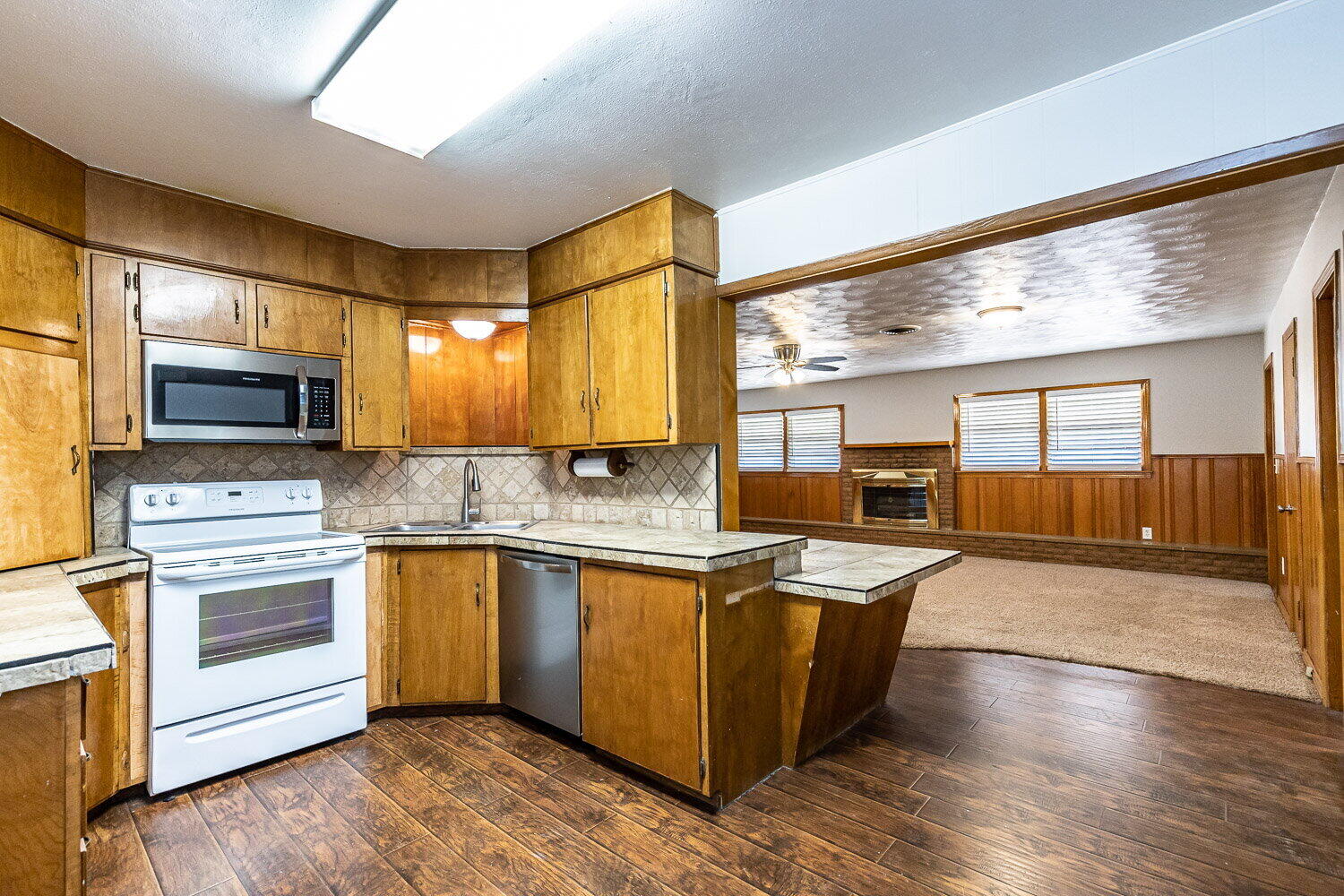 2603 39th Street Lubbock, TX 79413 - Photo 4 of 19 a large kitchen with stainless steel appliances granite countertop a stove and a sink