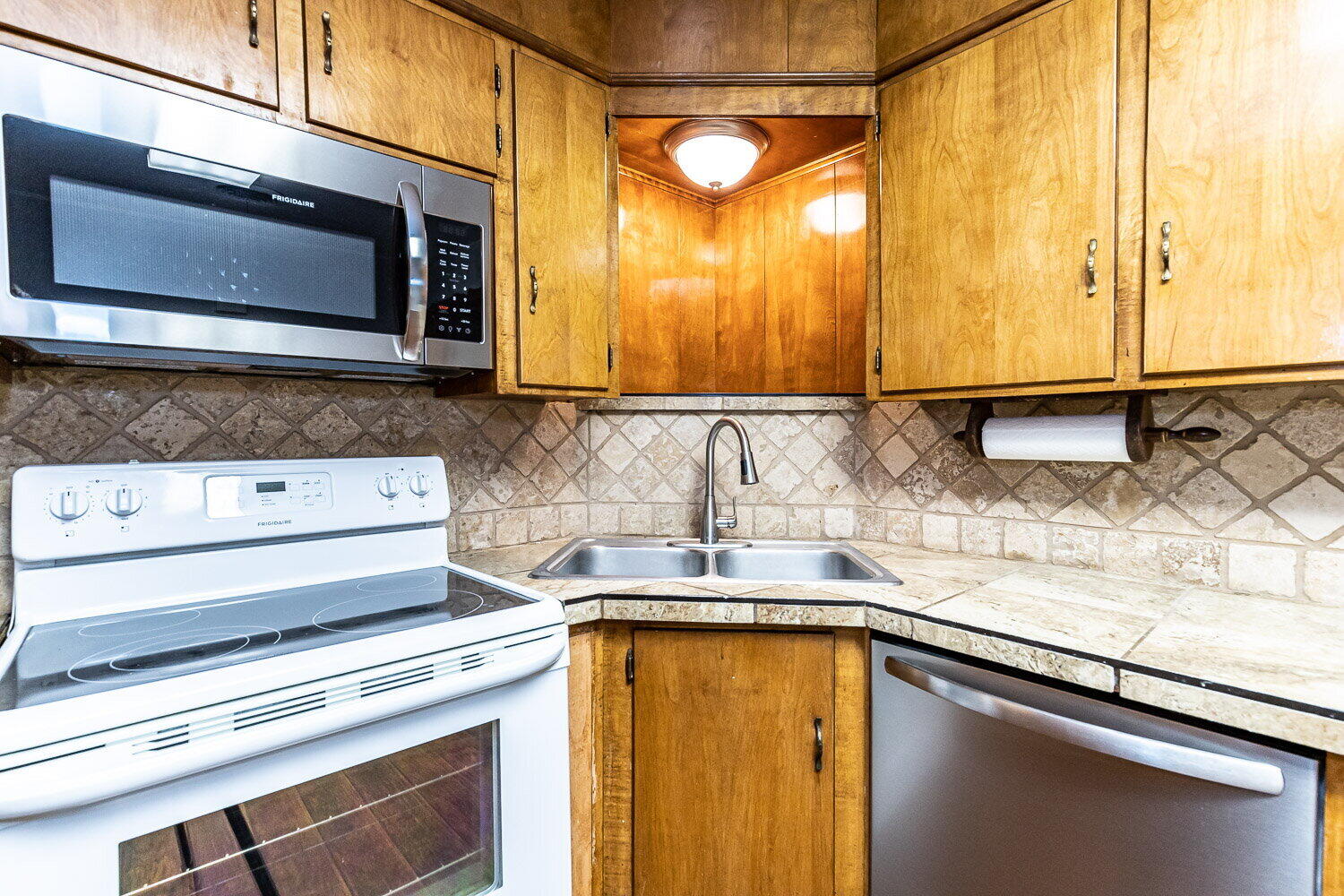 2603 39th Street Lubbock, TX 79413 - Photo 5 of 19 a kitchen with stainless steel appliances granite countertop a sink and a microwave
