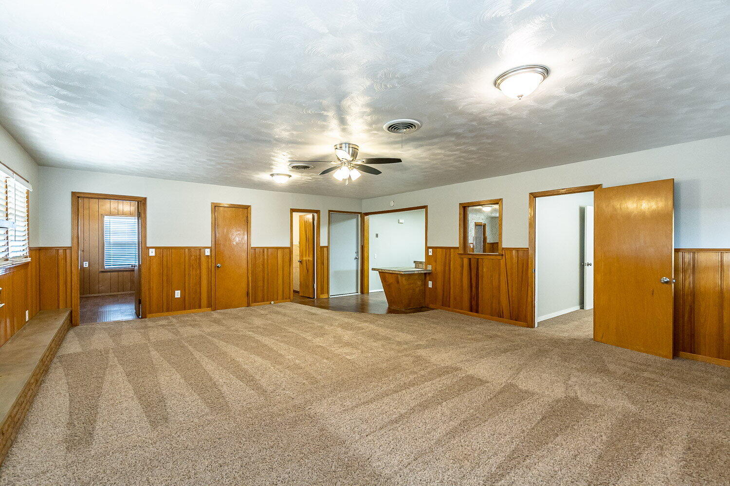 2603 39th Street Lubbock, TX 79413 - Photo 9 of 19 a large room with a large bed and ceiling fan