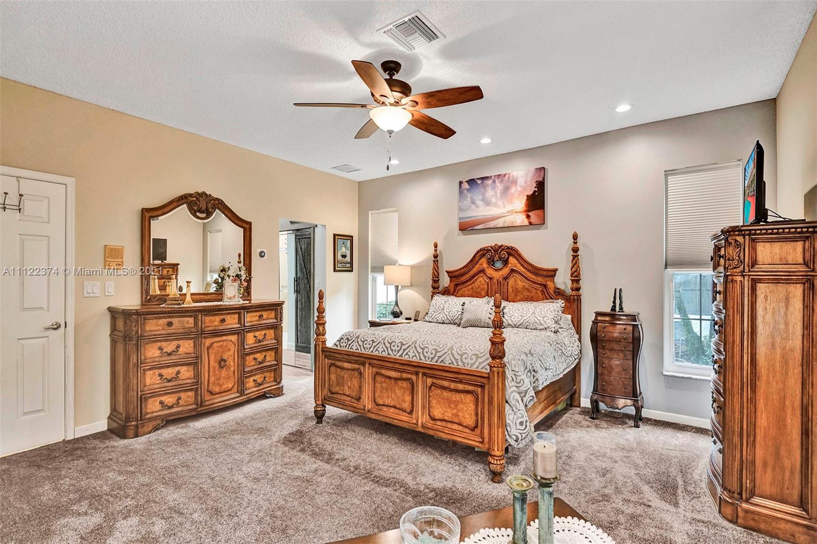 19609 Sedgefield Terrace Boca Raton, FL 33498 - Photo 23 of 43 a bedroom with a bed and a dresser