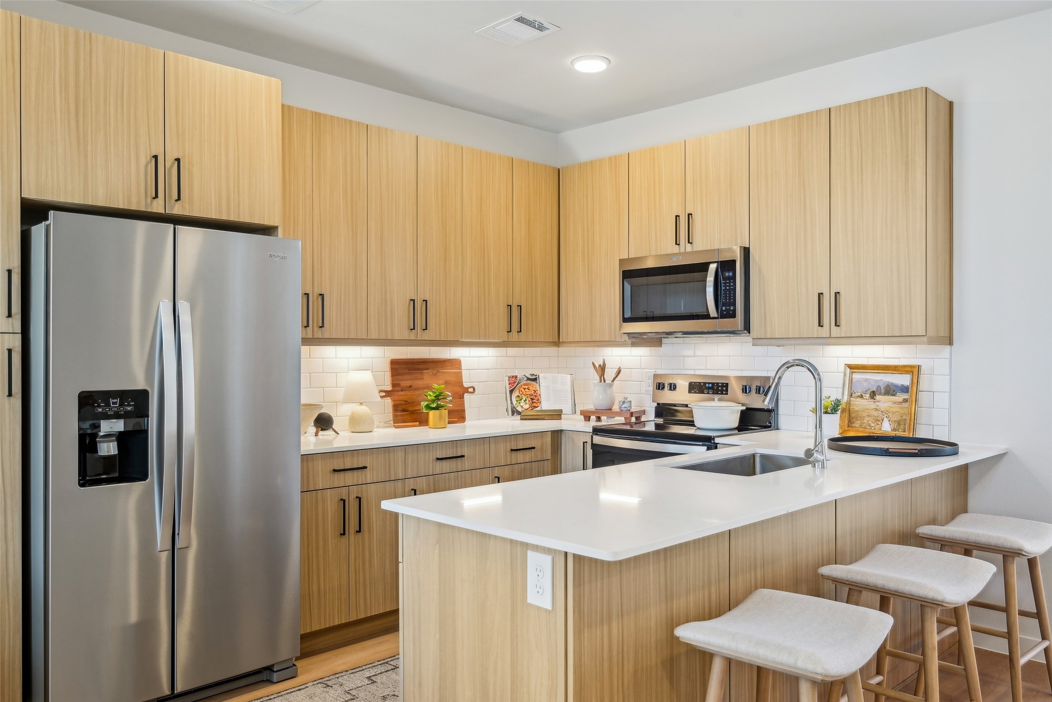 3651-318 South Custer Road McKinney, TX 75070 - Photo 12 of 28 a kitchen with stainless steel appliances a refrigerator a sink a stove a microwave a counter space and cabinets