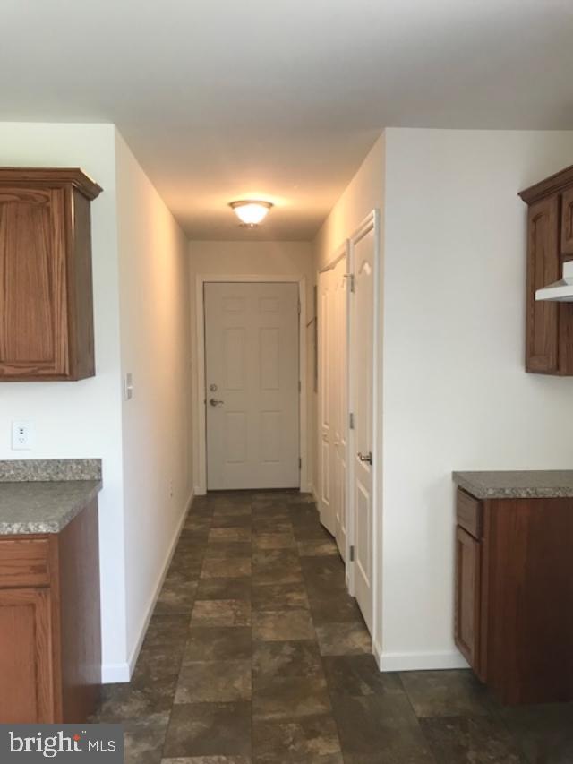 10880 North Old State Road Ellendale, DE 19941 - Photo 14 of 30 hallway to laundry closet and garage