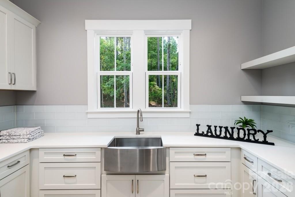 116 Silver Falls Road Troutman, NC 28166 - Photo 25 of 46 a kitchen with a stove and a white cabinets