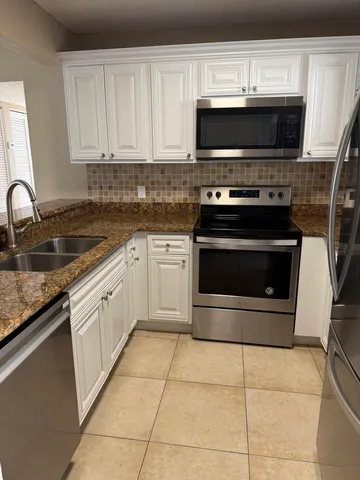 a kitchen with a stove and a microwave