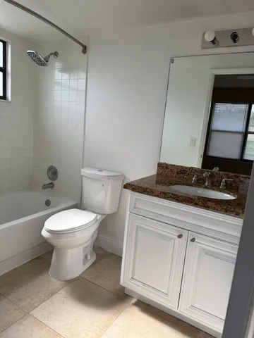 a bathroom with a toilet sink and shower