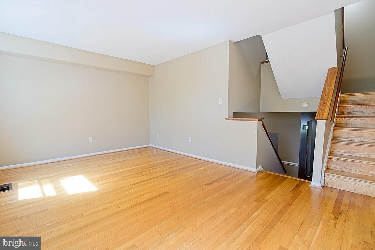 9054 Canterbury Riding, Unit 147 Laurel, MD 20723 - Photo 7 of 15 a view of empty room with wooden floor and fan
