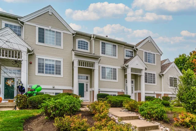 a kitchen with stainless steel appliances granite countertop a stove a refrigerator and a sink with wooden floor