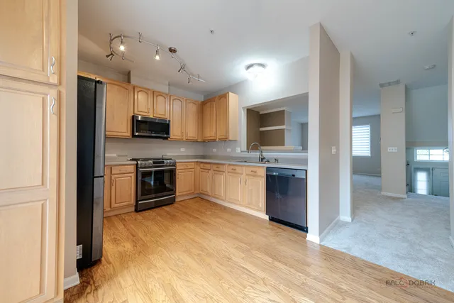 a kitchen with granite countertop a stove top oven sink and cabinets