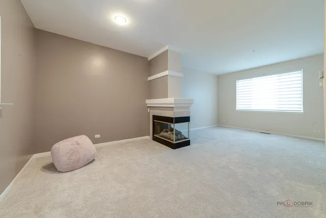 a living room with a fireplace and a fireplace