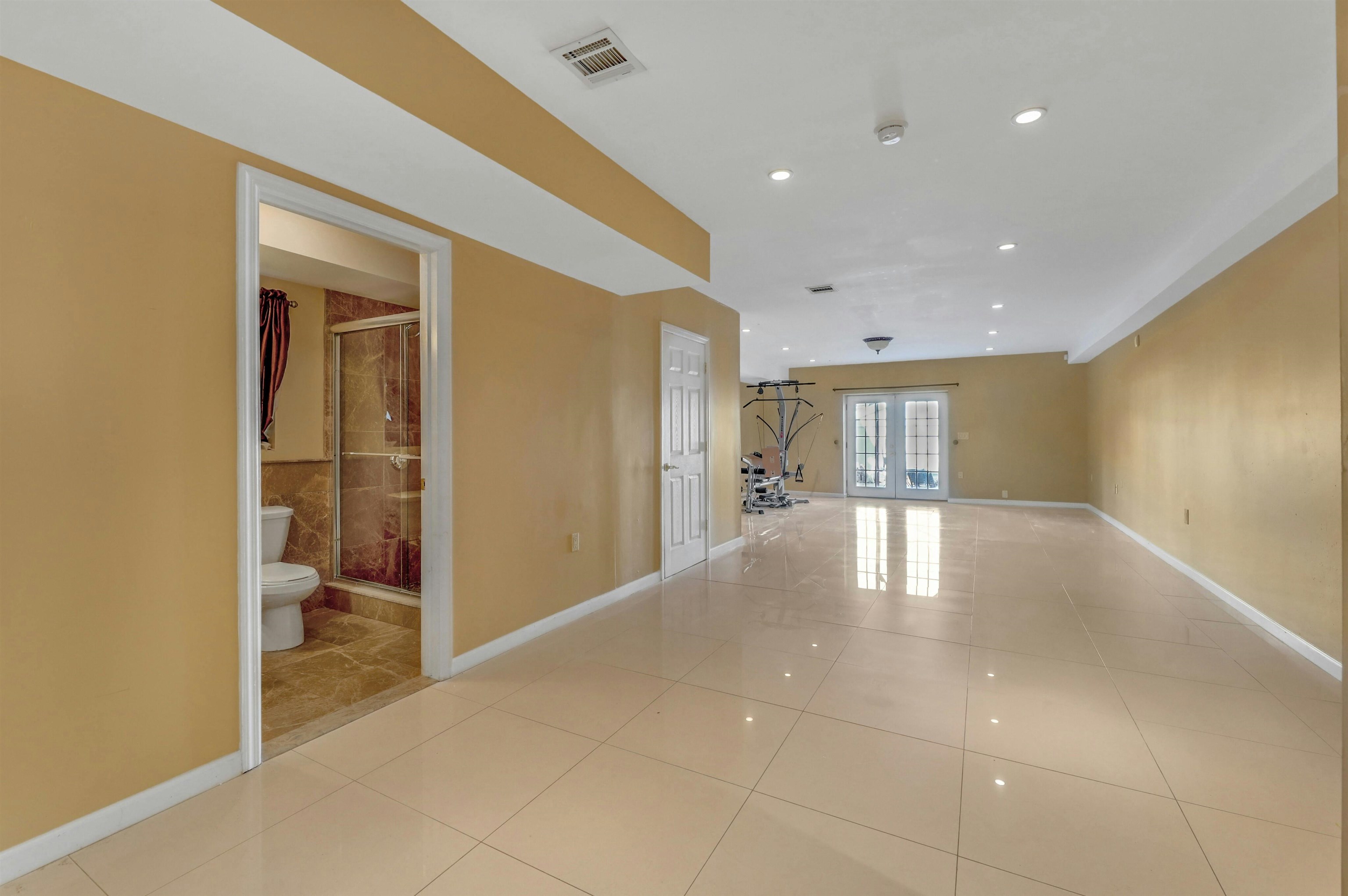 733 Chestnut Street, Unit A Secaucus, NJ 07094 - Photo 18 of 20 a view of a hallway with wooden floor and a bathroom