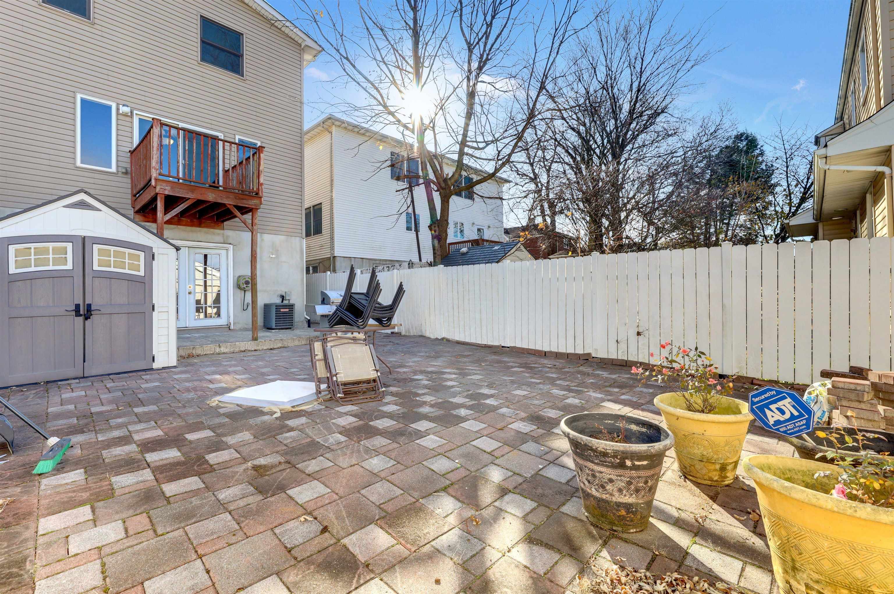 733 Chestnut Street, Unit A Secaucus, NJ 07094 - Photo 20 of 20 a backyard of a house with table and chairs