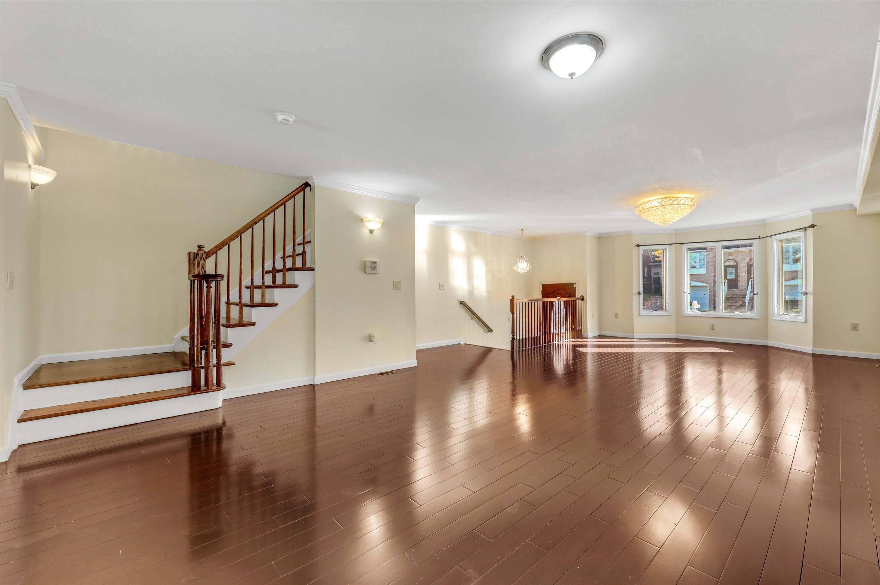 733 Chestnut Street, Unit A Secaucus, NJ 07094 - Photo 4 of 20 a view of empty room with wooden floor and floor to ceiling window