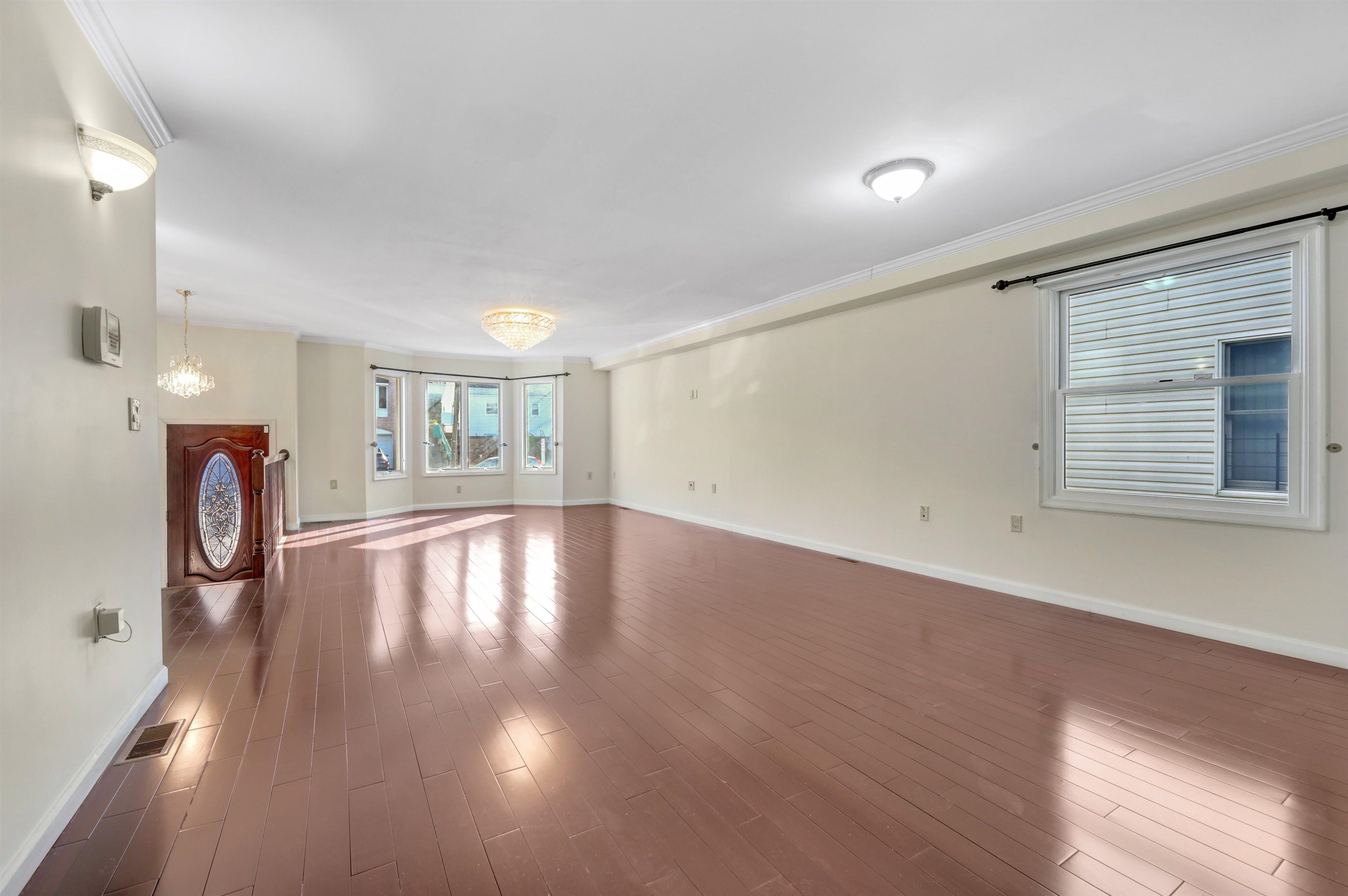 733 Chestnut Street, Unit A Secaucus, NJ 07094 - Photo 5 of 20 a view of empty room with wooden floor and fan