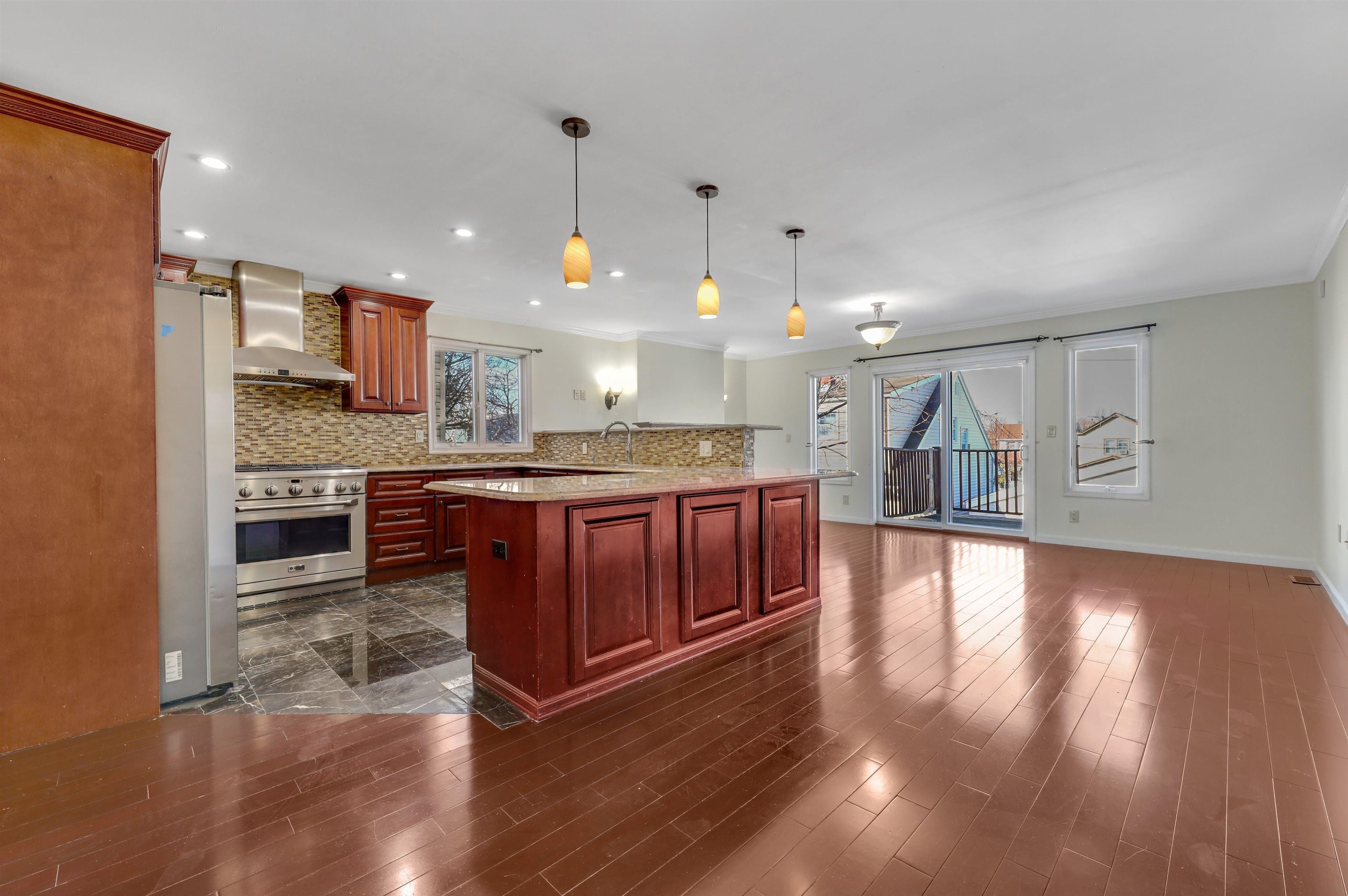 733 Chestnut Street, Unit A Secaucus, NJ 07094 - Photo 6 of 20 a kitchen with stainless steel appliances granite countertop a stove and a wooden floors
