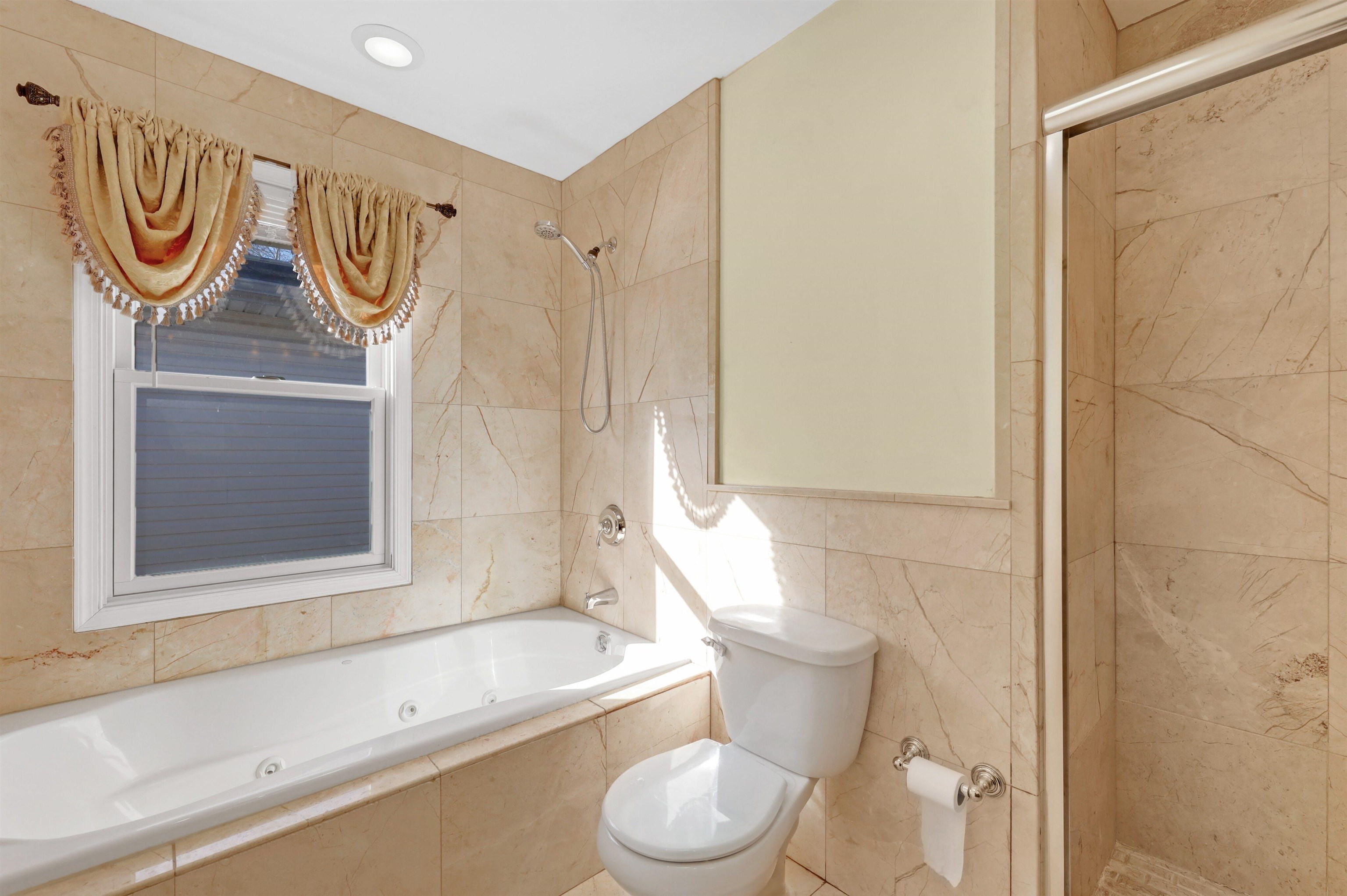 733 Chestnut Street, Unit A Secaucus, NJ 07094 - Photo 10 of 20 a bathroom with a sink a toilet and a shower