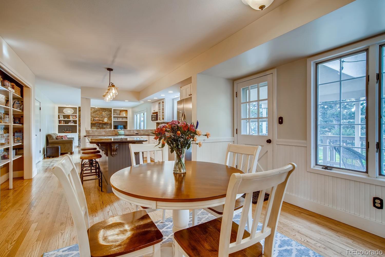 1894 La Quinta Circle Evergreen, CO 80439 - Photo 15 of 36 a dining room with furniture and wooden floor