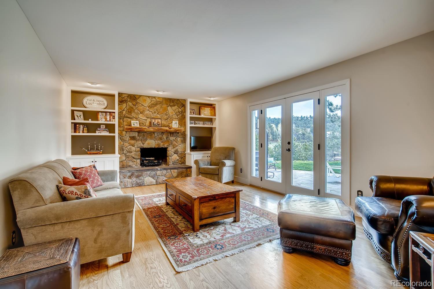 1894 La Quinta Circle Evergreen, CO 80439 - Photo 16 of 36 a living room with furniture and a floor to ceiling window