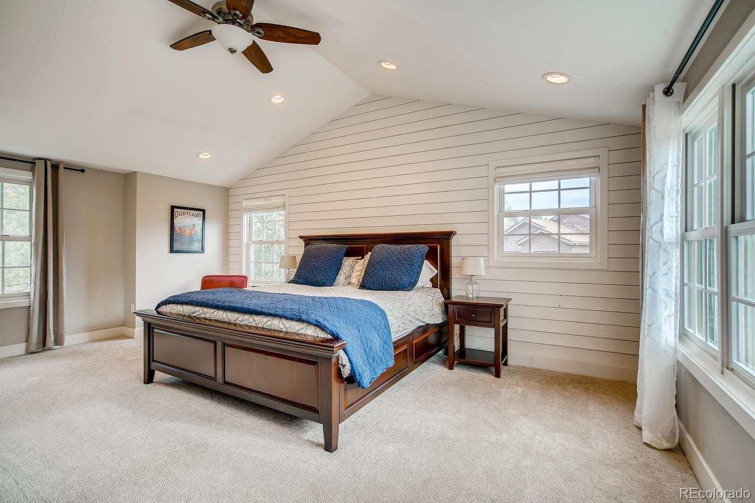 1894 La Quinta Circle Evergreen, CO 80439 - Photo 19 of 36 a spacious bedroom with a bed and a chandelier