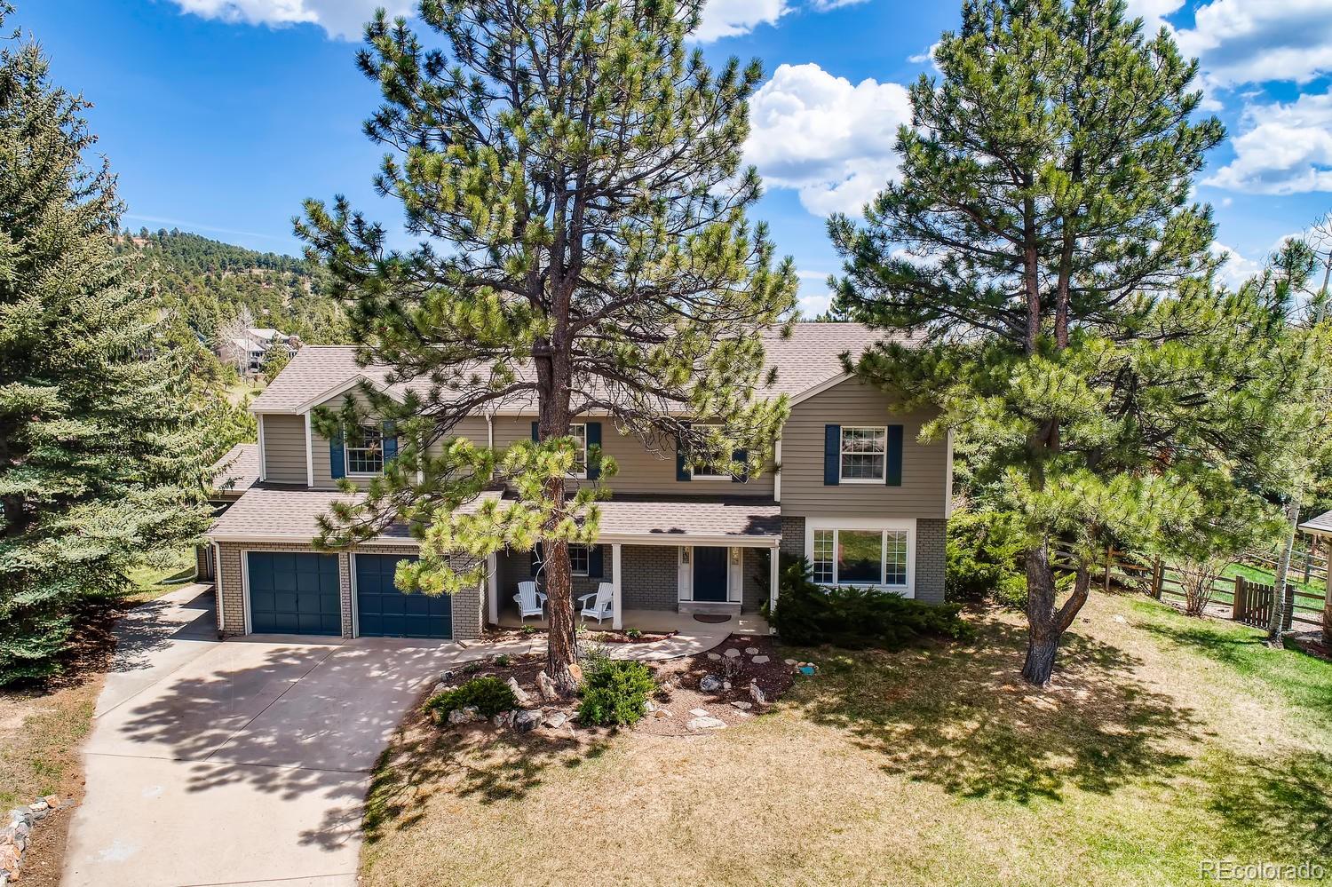 1894 La Quinta Circle Evergreen, CO 80439 - Photo 2 of 36 a front view of a house with a yard