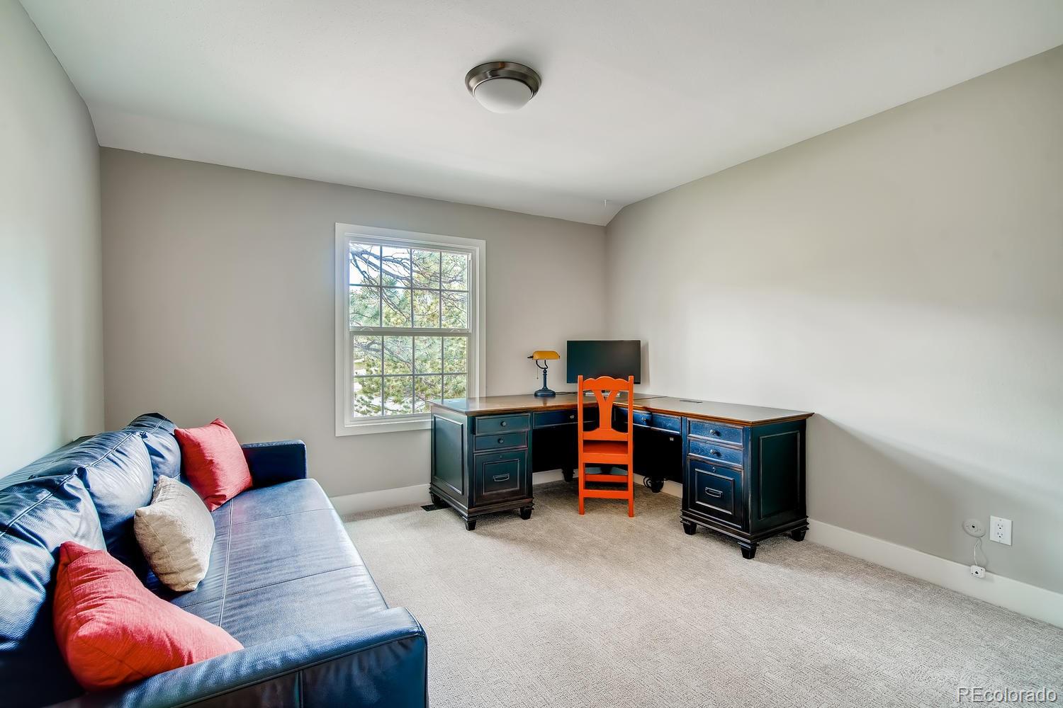 1894 La Quinta Circle Evergreen, CO 80439 - Photo 25 of 36 a bedroom with furniture and a window